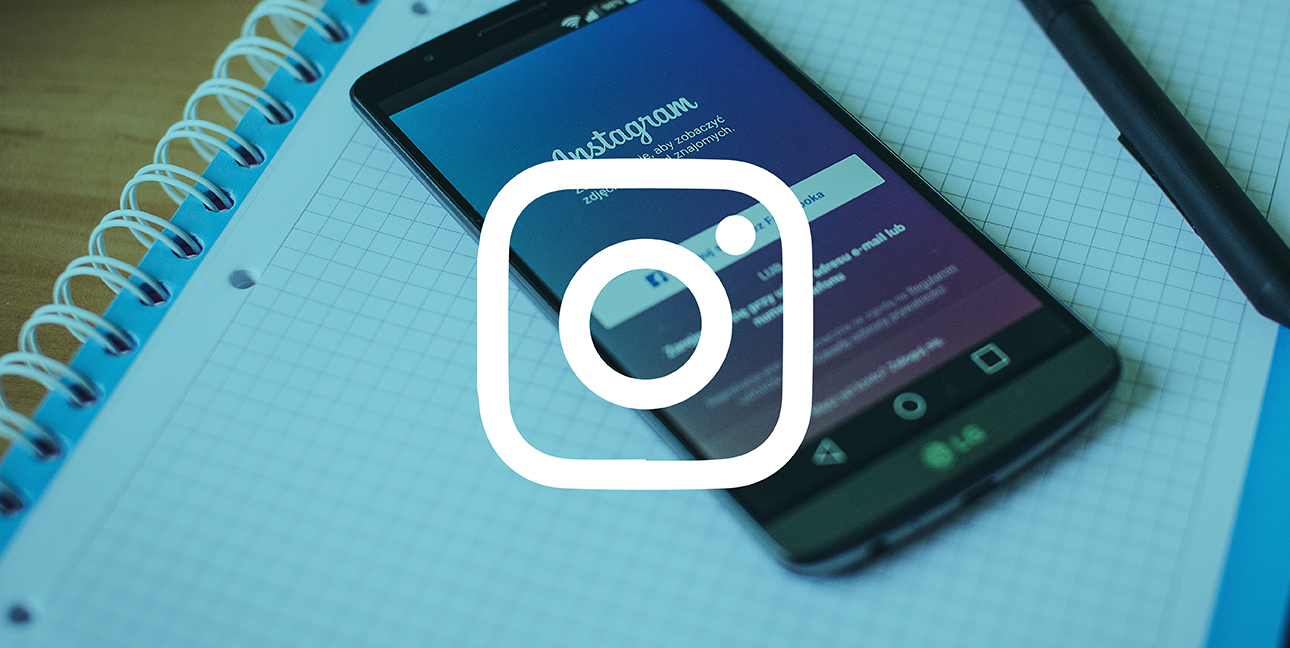 a phone sits on top of graph paper as it displays the login screen for instagram - top instagram brands to follow